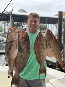 A man holding a group of fish.